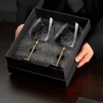 Elegant crystal wine glass set on a wooden table with soft lighting