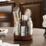 Rotating pencil holder on a wooden desk with a lamp and framed photo in the background.