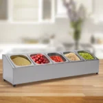 Stainless steel spice rack with 5 pans and lids on kitchen countertop