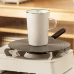 Enamel baking measuring cup with dual scale markings on a kitchen counter