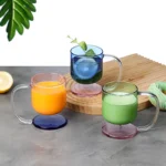 Colorful borosilicate glass drinking glasses on a wooden table