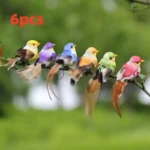 Set of 6 simulation feather birds in assorted colors, arranged on a rustic wooden table for a garden decor display.
