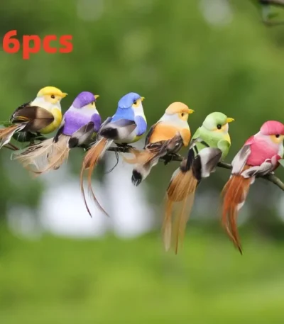 Set of fake bird decorations in various colors perched on a branch