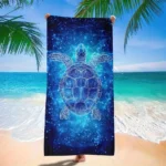 Blue star turtle quick dry beach towel on sand with ocean background
