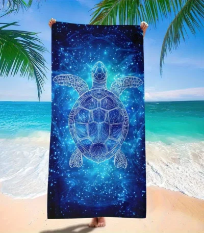 Blue star turtle quick dry beach towel on sand with ocean background