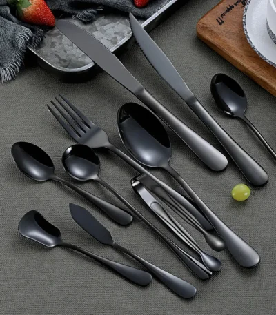 Elegant black stainless steel flatware set with mirror finish on a dining table
