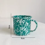 Retro enamel dinner plate with splash ink design on a wooden table