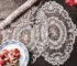 Vintage lace embroidered table mats on a dining table with elegant dinnerware
