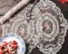 Vintage lace embroidered table mats on a dining table with elegant dinnerware