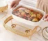 Ceramic dinnerware set with lid and candle holder on a wooden table
