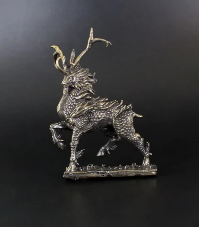 Retro copper figurine of a fire kirin on a desk