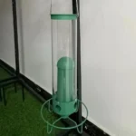 Hanging squirrel proof bird feeder in garden with a chickadee feeding