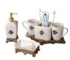 Vintage Court metallic ceramic lotion bottle in gold finish, placed on a marble bathroom countertop with soft lighting.