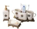 Vintage Court metallic ceramic lotion bottle in gold finish, placed on a marble bathroom countertop with soft lighting.