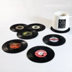 Set of vinyl record coasters on a wooden table
