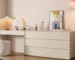 White modern minimalist solid wood dresser with six drawers in a bright bedroom