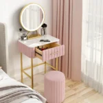 Marble top dressing table with lighted mirror and stool in a bedroom setting