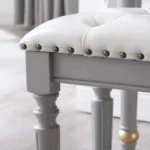 Modern white dressing table with mirror and stool in a bedroom setting