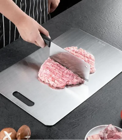 Double thick titanium cutting board with juice groove on a kitchen countertop