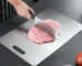 Double thick titanium cutting board with juice groove on a kitchen countertop