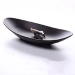 Black melamine dinner plates stacked elegantly on a wooden table