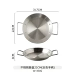 Stainless steel paella pan with double ears on a stove