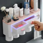 Complete bathroom accessories set: toothbrush holder, toothpaste dispenser, and cup on a vanity counter.