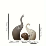 Ceramic elephant family grouping on a minimalist console table, with a plant in the background.