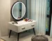 Modern dressing table with jewelry storage in a bright bedroom setup