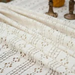 Retro polka dot tablecloth with fringe on a wooden table