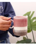 Large ceramic coffee mug with retro design and handle on wooden table