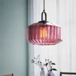 Modern colored glass pendant lamp illuminating a cozy dining room with vibrant hues