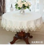 Elegant lace tablecloth with rose gold embroidery on a dining table