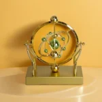 Ornament displayed on a marble surface, solar system design with glowing planets, stars reflected on the base.