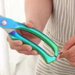 Goldoma heavy duty kitchen shears cutting through chicken bone on cutting board