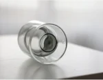 Clear double wall insulated glass mug with espresso coffee on wooden table