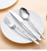 Luxury stainless steel flatware set with diamond 3D texture on a wooden table