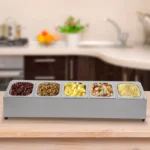 Stainless steel spice rack with 5 pans and lids on kitchen countertop