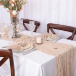 Boho cheesecloth table runner and napkins set as rustic table linens on a wooden table