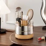 360-degree rotating pen holder in pastel blue, placed next to a laptop on a glass desk.