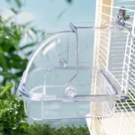 Bird bath tub with a parakeet perched on the rim, splashing water.
