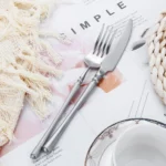Matte gold flatware set with antique finish arranged on a wooden table