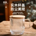 Japanese-style vertical stripes bamboo lid drinking glass with handle on wooden table