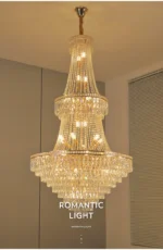 Modern crystal chandelier for dining room hanging over a wooden table with warm glow