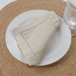White linen cloth napkins hemstitched cocktail napkins set of 100 on wooden table