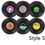 Set of vinyl record coasters on a wooden table