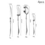 Elegant French stainless steel cutlery set with pointed tail handles on a wooden table