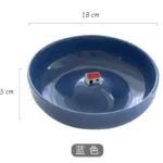 Set of abstract ceramic plates with colorful three-dimensional designs on a dining table