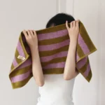 Woman relaxing on a retro striped beach towel for women by Goldoma