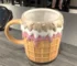 Cute donut ceramic coffee mug on a desk with cozy decor